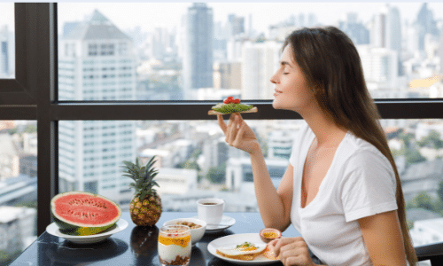 Mindful eating. Woman eating with closed eyes.
