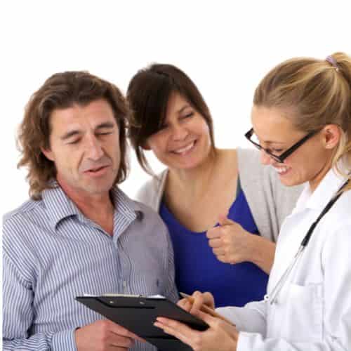 Doctor telling couple of good news