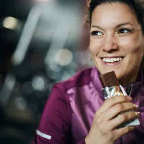 Woman eating protein bar